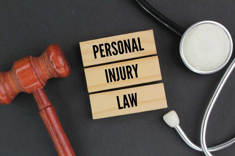 Injured adult writing symptoms in a journal beside medication bottles and medical paperwork at a kitchen table.